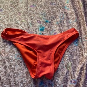 these are an dark orange pair of swim wear bottoms